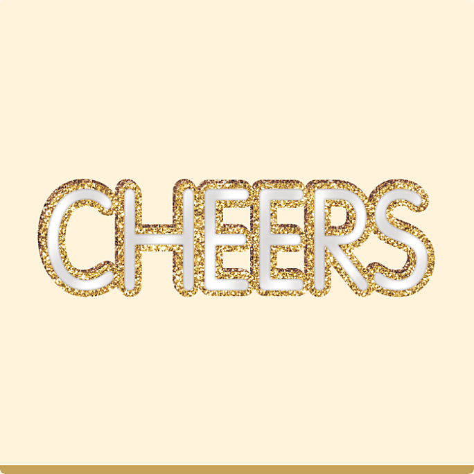 A standing MDF mirrored “Cheers” decorative sign with a gold glitter outline around each letter.