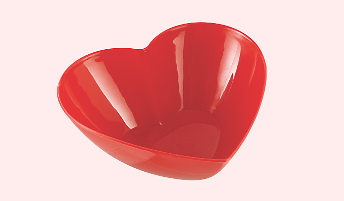 A red plastic Valentine&#39;s Day heart-shaped bowl. 