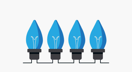 Four blue Christmas light bulbs with black bases.