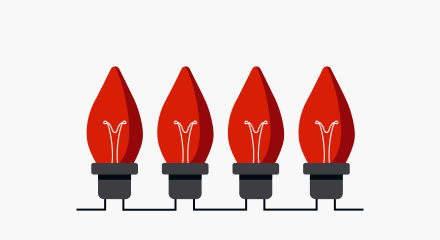 Four red Christmas light bulbs with black bases.