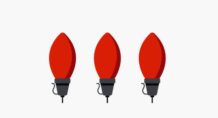Three oversized red Christmas light bulbs with black bases.