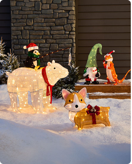 Playful outdoor Christmas display featuring illuminated animal characters, a polar bear and colourful holiday decor.